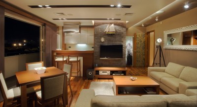 Modern interior of an apartment with handmade furniture and lighting equipment.